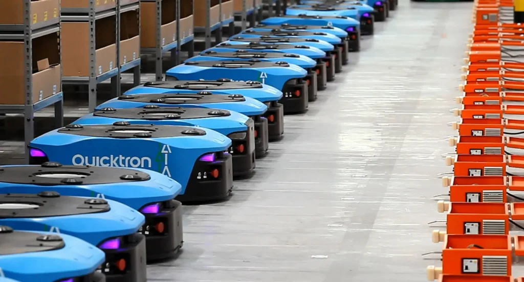 Quicktron warehouse robots lined up near charging stations