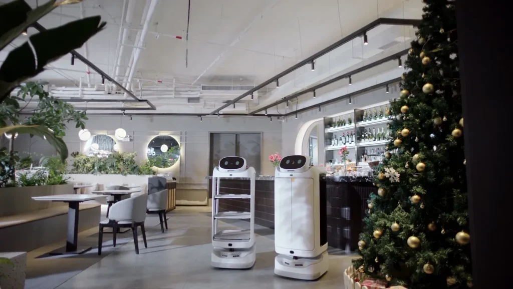 Two service robots inside modern restaurant