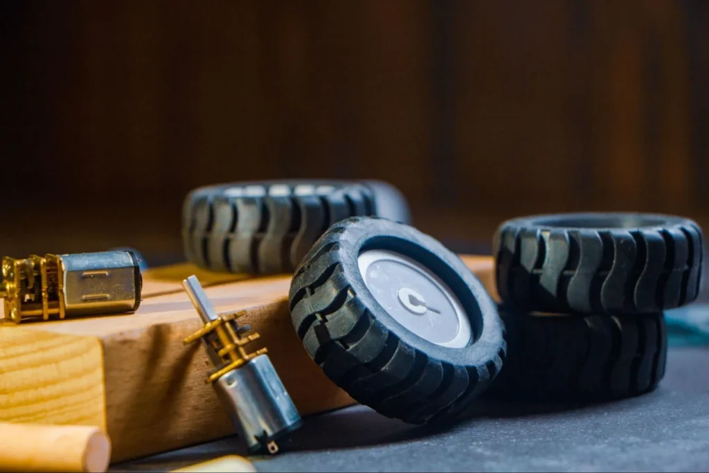 Small motors and wheels used in robotic actuator systems