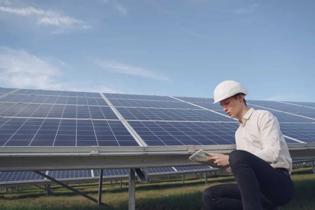 Engineer checking solar panels with tablet