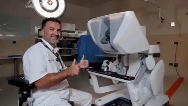 Doctor seated near surgical robot console