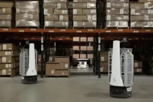 Warehouse robots moving through storage aisles