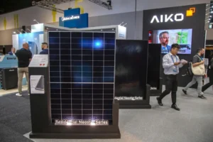 AIKO Neostar solar panel displayed at a clean energy trade show.