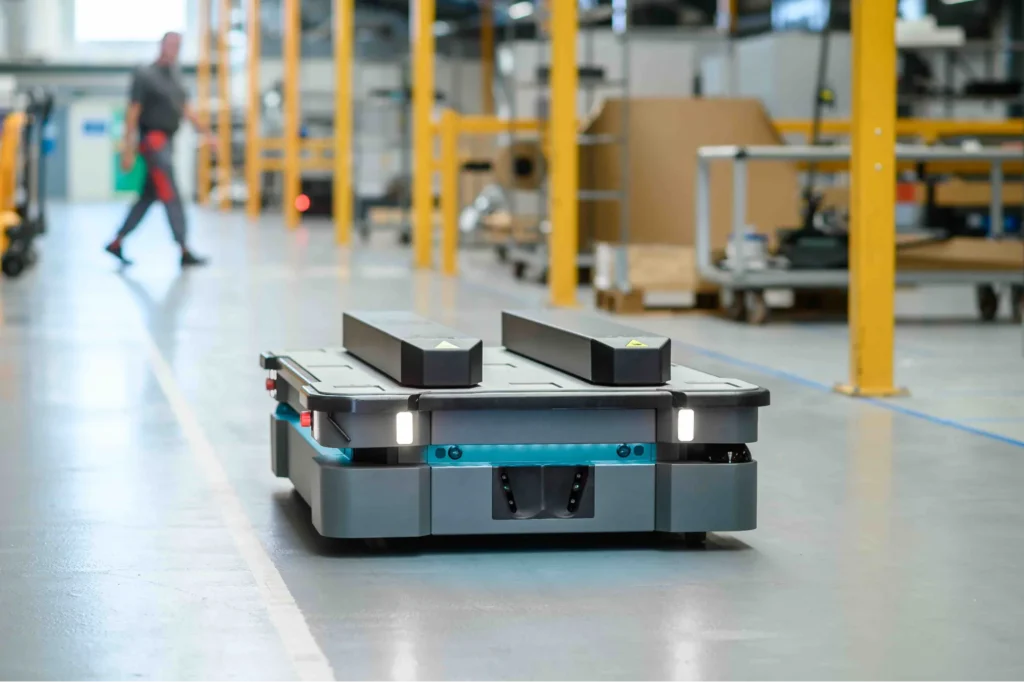 Autonomous mobile robot moving through a factory aisle
