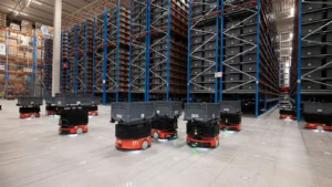 AMR fleet moving bins in an automated warehouse