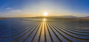 Chinese solar modules spread across a large solar farm at sunset
