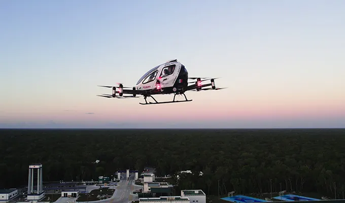 EHang eVTOL landing near a modern passenger site