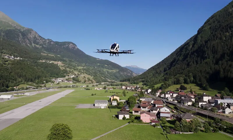 EHang eVTOL flying above a mountain valley