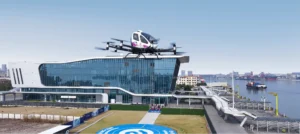 EHang eVTOL flying at sunset over a forest site