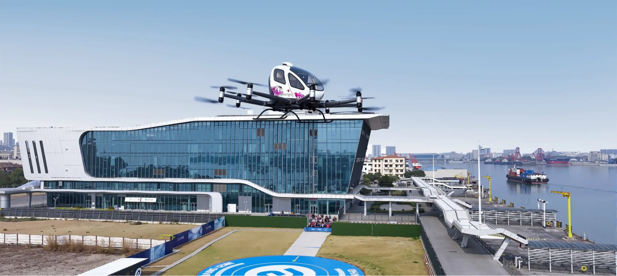 EHang eVTOL flying at sunset over a forest site