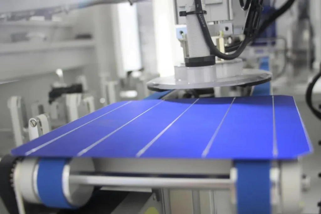 Blue solar cell moving through automated production machine