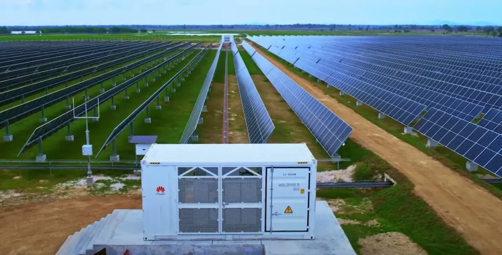 Huawei inverter station beside large utility scale solar farm