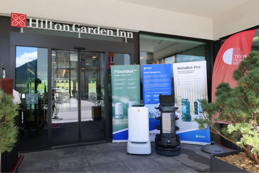 Pudu robots outside hotel entrance