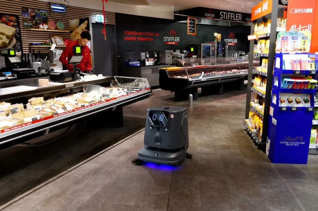 Pudu cleaning robot in supermarket aisle