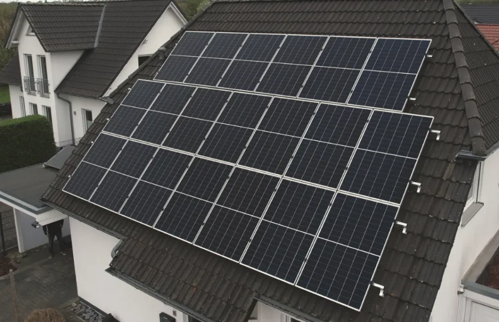 Black AIKO solar panels installed on a modern home rooftop.