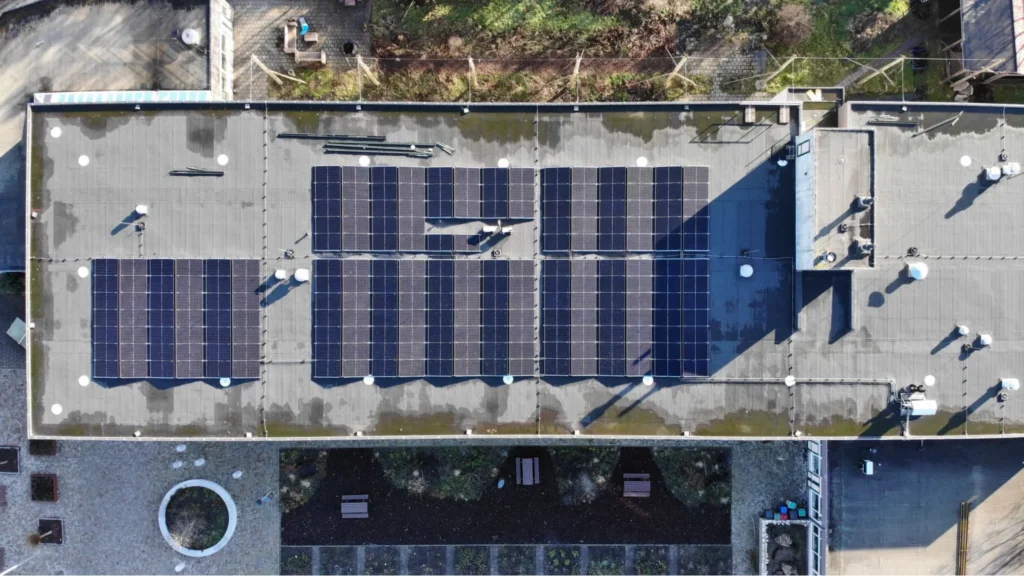 Solar panels installed on modern villa rooftops with poolside outdoor space