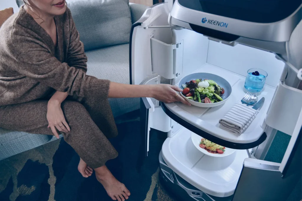 Robot serving food to a seated guest