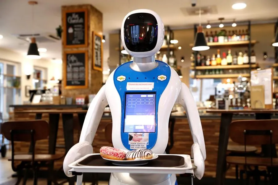Robot waiter carrying desserts in a café