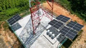 Solar panels powering equipment near a telecom tower