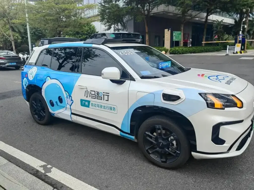 Blue and white robot taxi parked on a city street