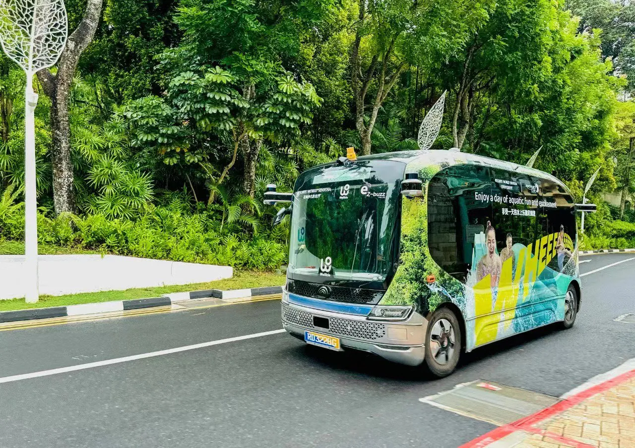 Autonomous shuttle traveling through a green urban area