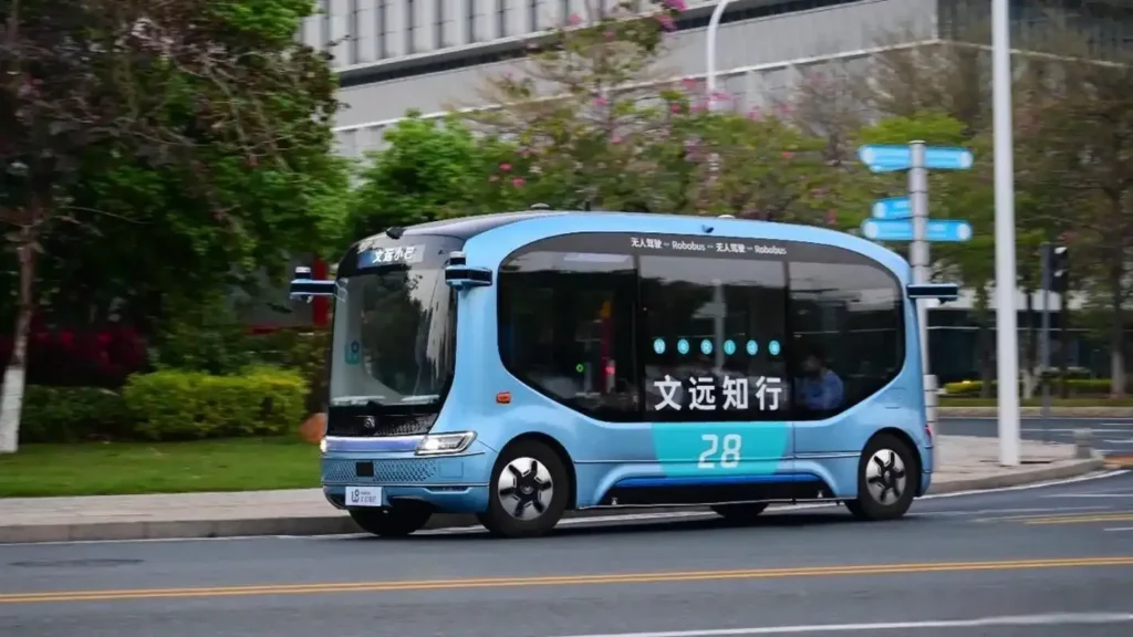 Blue autonomous shuttle driving on a city road
