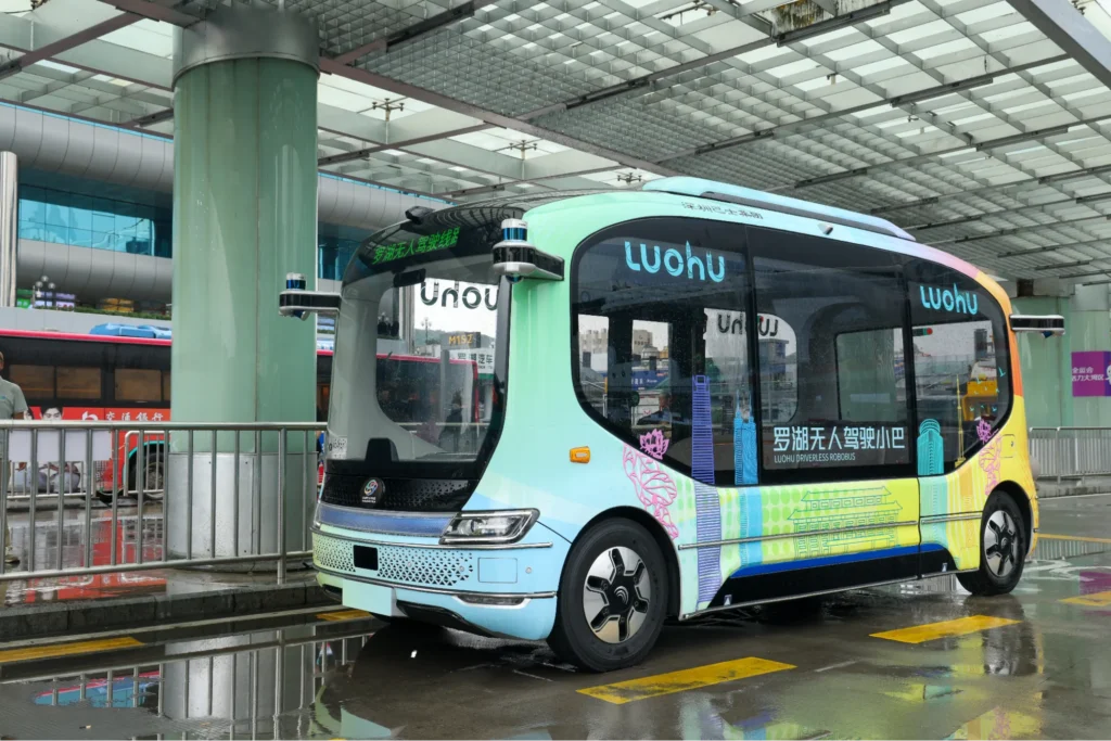 Driverless shuttle waiting at a covered transit station