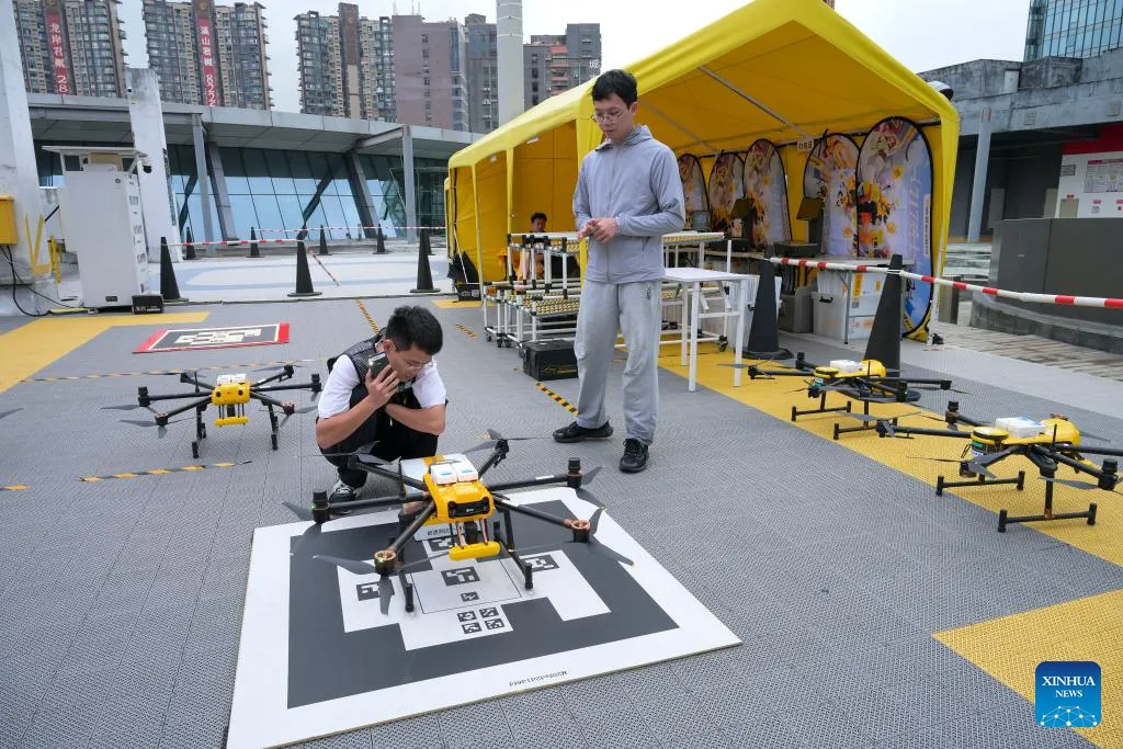 Drone testing zone with operators and delivery drones on landing pads