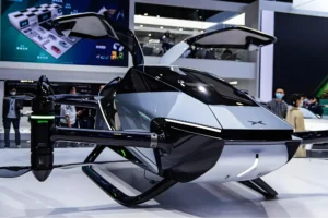 Futuristic electric VTOL aircraft displayed at an indoor technology exhibition