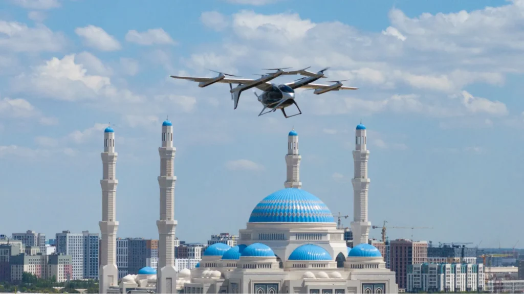 Electric VTOL aircraft flying above a blue domed mosque and city skyline