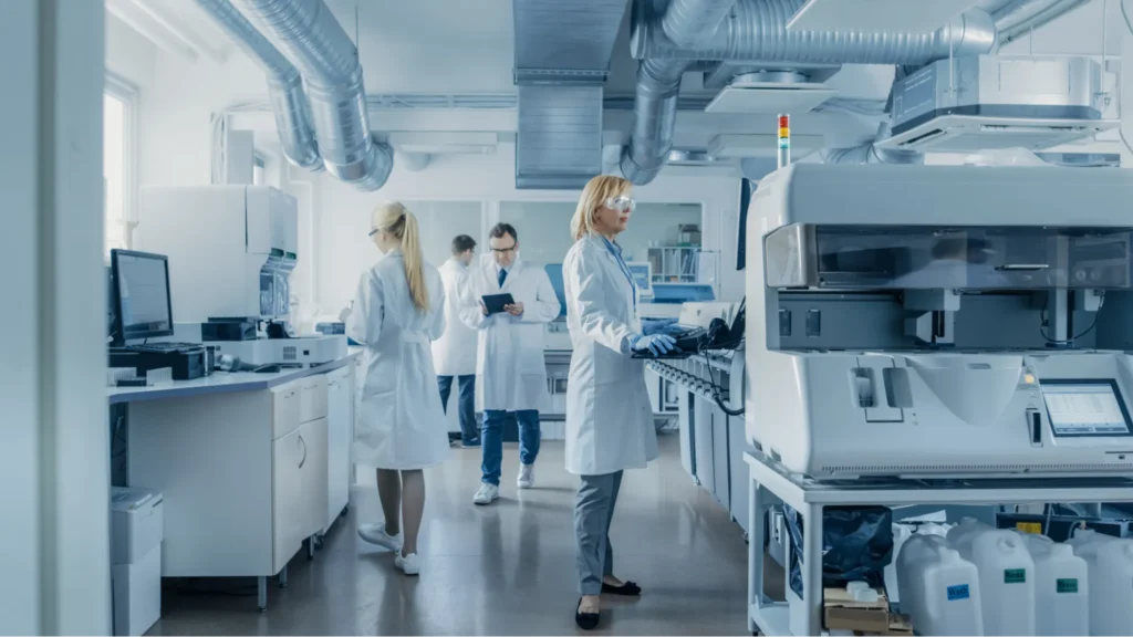Scientists working with advanced equipment in a biotechnology laboratory