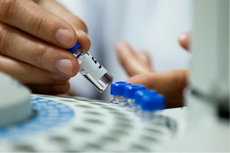Close-up of a researcher handling laboratory samples for testing
