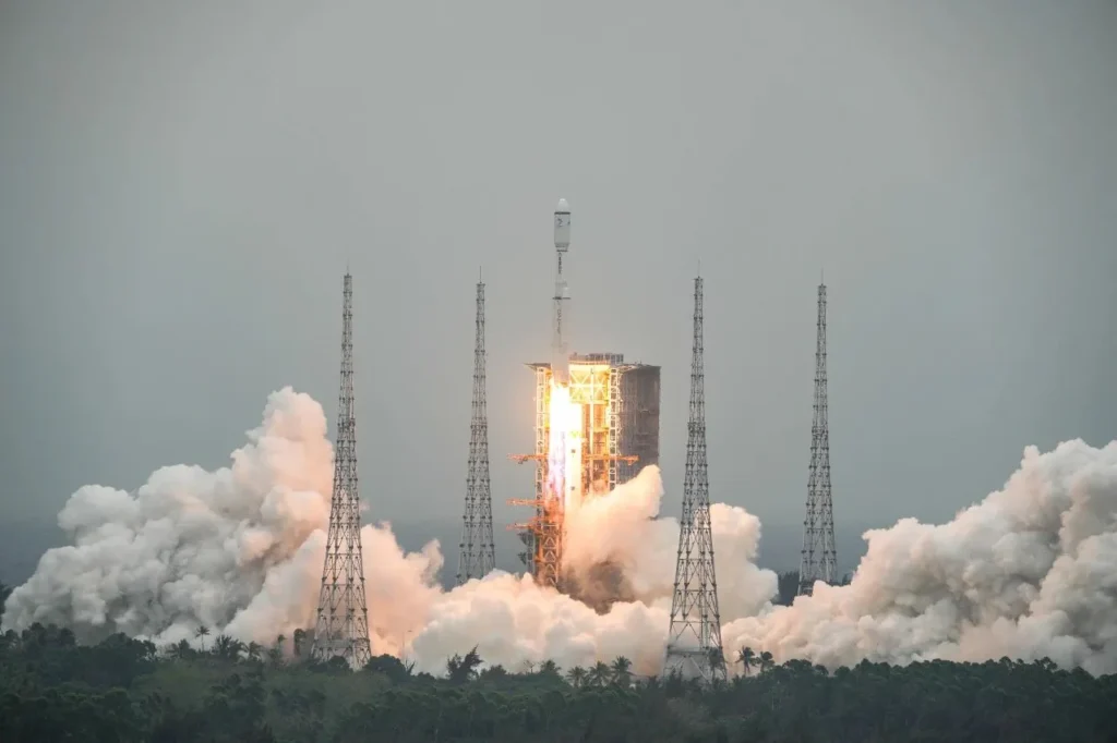 Chinese rocket launching amid smoke from a space launch center